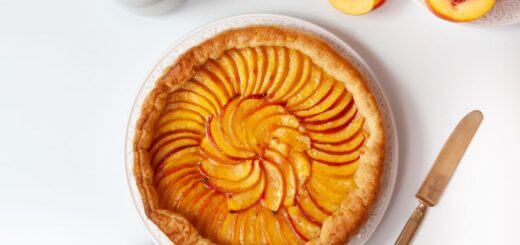 flat lay of peaches cake and teapot
